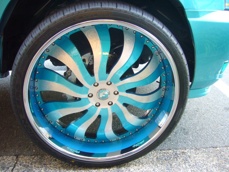 The rims on the turqoise car