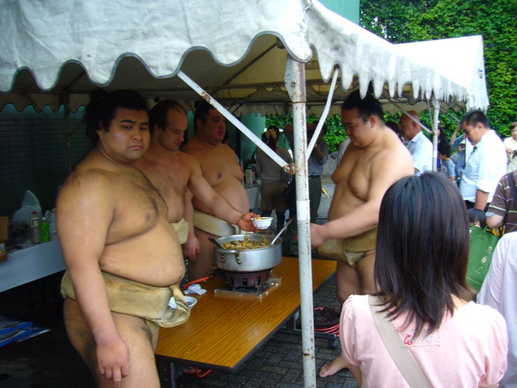Sumo wrestlers handing out chankonabe Sumo wrestlers handing out chankonabe
