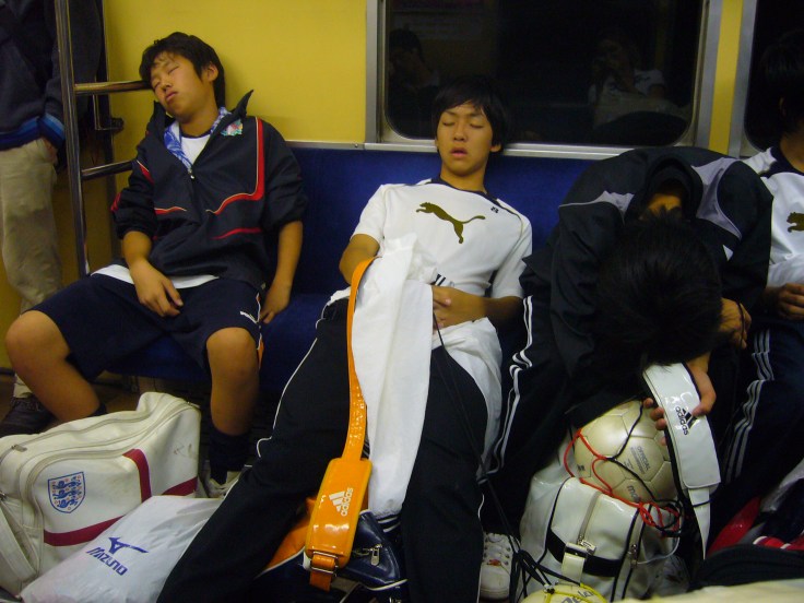 kids sleeping on the train in Japan
