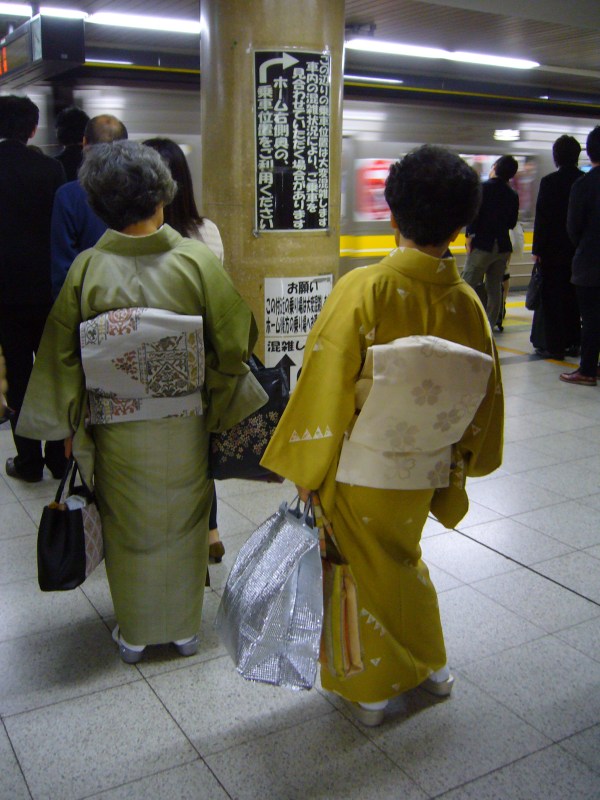 Japanese ladies in kimono waiting for the train
